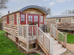 a log cabin with a staircase leading to a house at The White Princess in York