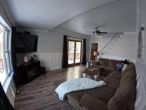 uma sala de estar com um sofá e uma televisão de ecrã plano em Gorgeous house by the lake em Timmins