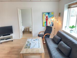 a living room with a couch and a table at Skjernaa-ferie/ Andersen Invest in Skjern
