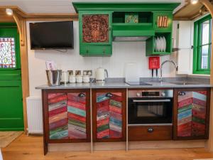 a kitchen with green cabinets and a counter at Folklore in York