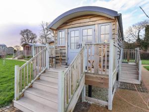 a tiny house with a wooden staircase and a door at The Fenton in York
