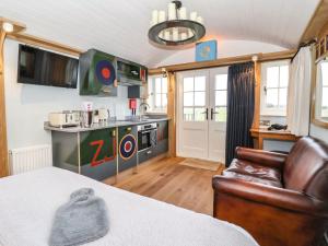a room with a kitchen with a bed and a chair at The Fenton in York +5 photos