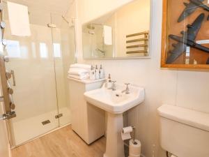 a white bathroom with a sink and a shower at The Fenton in York