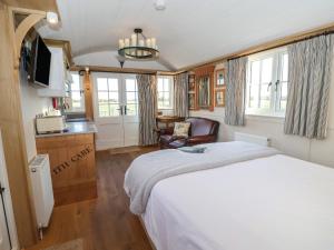 a bedroom with a large bed and a kitchen at The Egyptologist in York