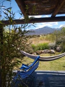 a couple of hammocks sitting next to a pool at Casa Entelequia in Las Compuertas