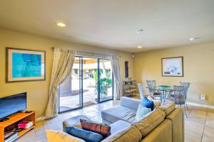 a living room with a couch and a tv at Carefree Casita with Outdoor Pool and Mountain View! in Carefree