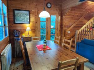 a dining room with a wooden table and chairs at El Pi Solitari in Camprodon