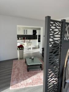 a living room with a coffee table and a kitchen at l'Ecrin du Bonheur in Turckheim +11 photos