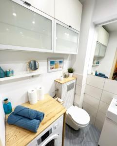 a small bathroom with a white washer and dryer at Warszawska 1 Apartament Giżycko in Giżycko