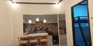 a kitchen with white cabinets and a brick wall at Lakeshore Villa in San Benito