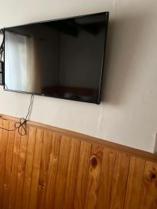 a flat screen tv hanging on a wall at Profe Nelson in Puerto Cisnes