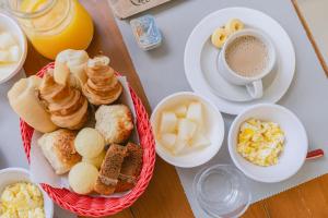 - une table avec des aliments pour le petit-déjeuner et une tasse de café dans l'établissement Pousada CafeMar Búzios, à Búzios
