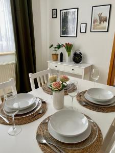 a dining room table with plates and wine glasses at Visit_Oberhof in Oberhof