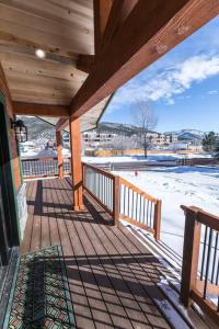 a porch of a house with snow on the ground at Modern Mountain Lodge Oasis w Hot Tub-Rio Grande Trail in Carbondale