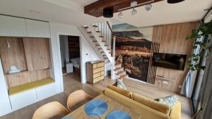 - un salon avec un canapé et un escalier dans l'établissement Brzuchem do góry, à Chocieszow