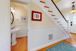 a bathroom with a sink and a staircase in a house at Town of Rehoboth Beach 314 Laurel St in Rehoboth Beach +24 photos