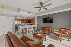 a living room with a couch and a table at “Lotusland” Origin at Seahaven! in Panama City Beach