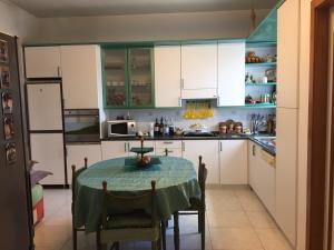 a kitchen with a table with a green table cloth on it at B&B DONNA PORZIA in Trani