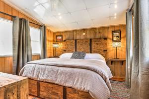 a bedroom with a bed in a room with wooden walls at Cozy Hatteras Island Abode about 1 Mi to Frisco Beach! in Frisco