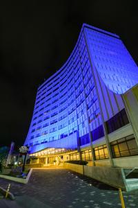 a building is lit up blue at night at Hotel Casino Internacional in Cúcuta