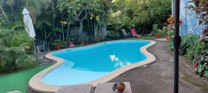 a large blue swimming pool with a person standing next to it at KazTiFahamAimée in Saint-Louis