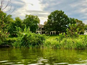 a house on the shore of a body of water at Tennessee Room at Tennessee RiverPlace in Chattanooga