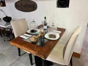 a wooden table with two plates of food on it at Villa Alba Boutique Hotel in Pescara
