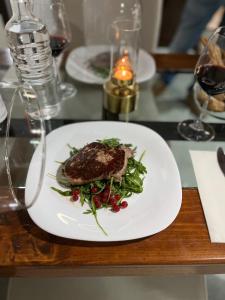 a white plate of food on a table at Villa Alba Boutique Hotel in Pescara