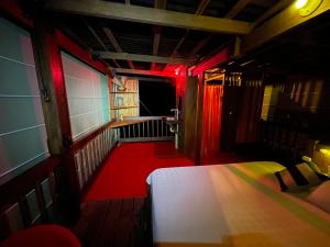 a small room with a bed and red lighting at La Kuka Hotel - Nuquí in Nuquí