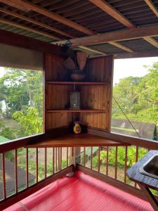 a screened in porch with a view of the yard at La Kuka Hotel - Nuquí in Nuquí