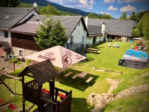 an overhead view of a backyard with a pool and an umbrella at Penzion Dolní Morava in Dolní Morava