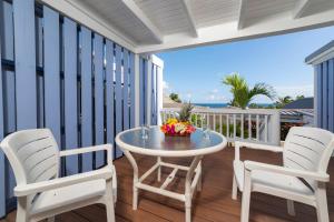 a patio with a table and chairs on a balcony at La Vista Resort in Simpson Bay