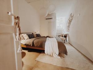 a bedroom with a bed in a white room at CASA NAUTILO - Porta Vecchia in Monopoli