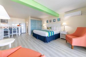 a hotel room with a bed and a kitchen at La Vista Resort in Simpson Bay