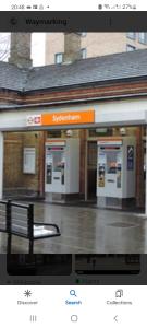 a train station with a bench in front of it at Sydenham Place in Forest Hill