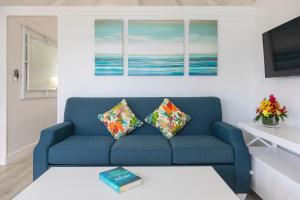 a living room with a blue couch with two pillows at La Vista Resort in Simpson Bay