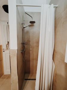 a shower with a shower curtain in a bathroom at CASA NAUTILO - Porta Vecchia in Monopoli