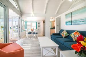 a living room with a blue couch and a table at La Vista Resort in Simpson Bay