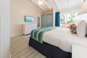 a bedroom with a large bed and a television at La Vista Resort in Simpson Bay