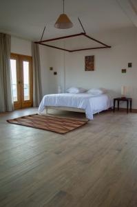 a bedroom with a bed and a rug on the floor at Sur la Plage Yenne in Yenne-Todé