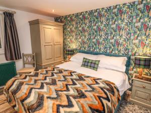 a bedroom with a bed with a patterned wall at Helm Crag in Grasmere