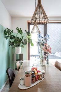 a dining room table with plants and jars on it at Boutique B&B Graaf in Ghent