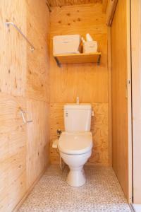 a bathroom with a toilet in a wooden wall at Izukogen tent resort - Vacation STAY 13377v in Ito