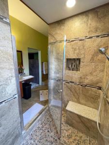 a bathroom with a shower with a glass door at Mountain View Vacation Home 