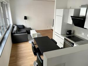 a kitchen and living room with a table and a couch at Modern Apartment in the center of Munich in Munich