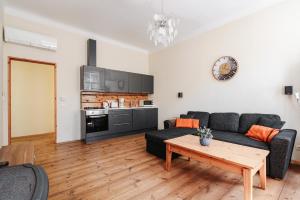 a living room with a couch and a table at AirHome - Owl's Nest 2 in Tallinn