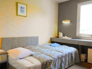 a bedroom with a bed and a window at Hotel Tsushima - Vacation STAY 64041v in Tsushima