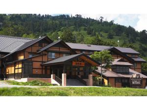 a large wooden house with a mountain in the background at Manzatei - Vacation STAY 27688v 