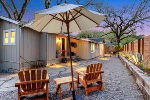 un patio con 2 sillas y una mesa con sombrilla en Wine Country Creekside Retreat With Hot Tub, en Glen Ellen