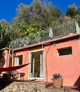a pink house with a balcony on top of it at Maisonnette avec escalier in Menton